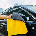 Double-sided microfiber towel used on a vehicle